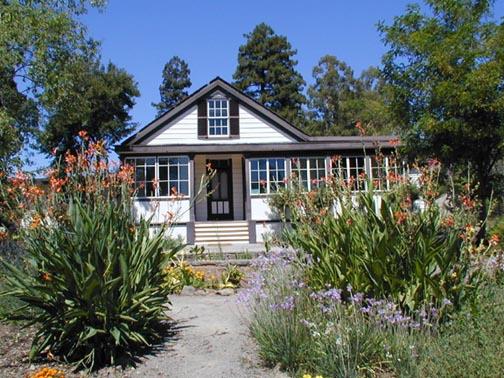 White cottage with brown trim.